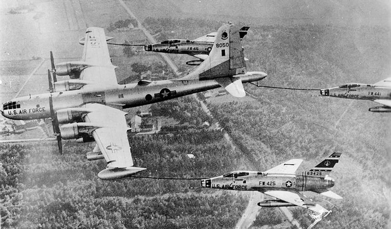 A Boeing KB-50J refuels a trio of North American F-100 Super Sabres. Note the wingtip fuel tanks and jet engines on this KB-50J, as well as the downward flight angle as the tanker “toboggans” to keep pace with the faster fighters. (US Air Force)